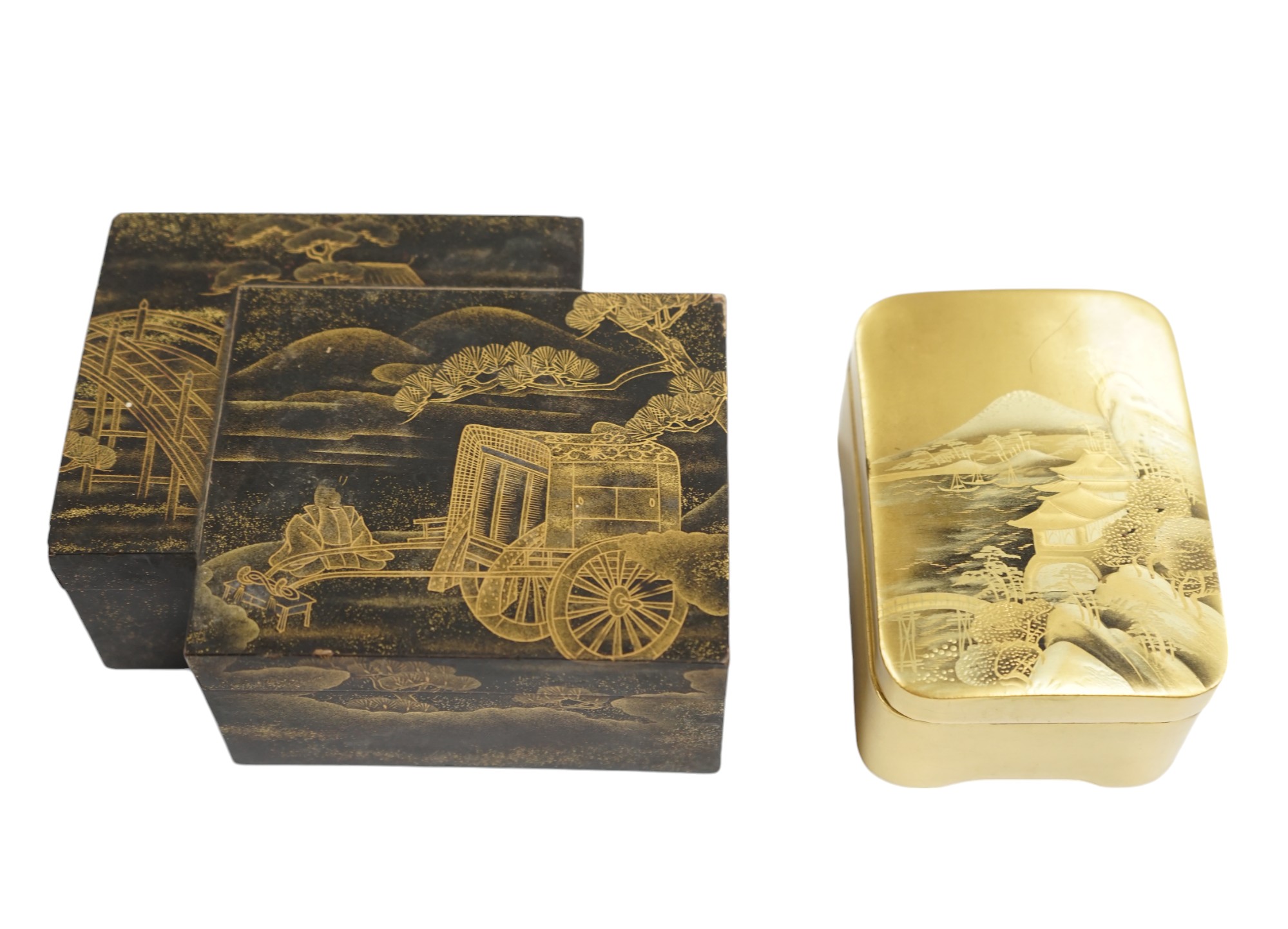 Two Japanese lacquer boxes: one black with gilt decoration, the other gilt with a scene of Mount Fuji etc, largest box 12cm wide. Condition - black and gilt box has some grazes to top edges, gilt box good